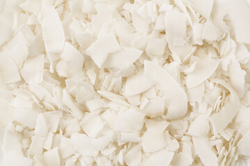 Fototapeta na wymiar Coconut flakes or chips background. Top view. Flat lay