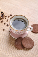Drink coaster with cup of coffee and cookies on wooden table