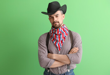 Handsome cowboy on green background