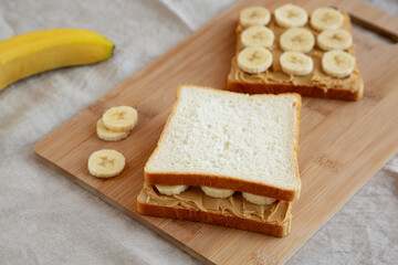 Homemade Peanut Butter Banana Sandwich on a Bamboo Board, side view.