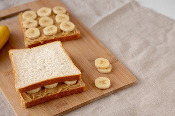 Homemade Peanut Butter Banana Sandwich on a Bamboo Board, side view.