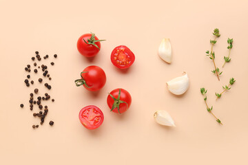 Composition with ripe cherry tomatoes, thyme, garlic and peppercorn on beige background