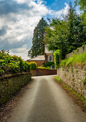Old brick georgian home behind garden wall seen from Church Hill in Ellesmere Shropshire