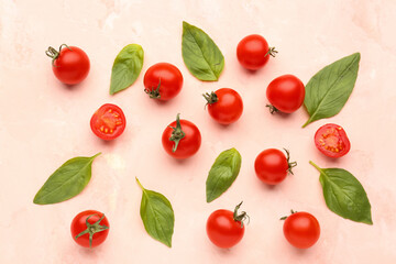 Composition with ripe cherry tomatoes and basil leaves on beige background