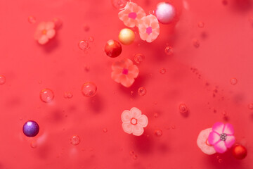 Colorful gel texture, clear skincare cream with bubbles and decorative figurines background, transparent beauty serum, colored cosmetic product close up