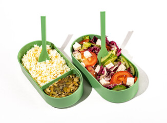 Healthy food in containers. Vegetable salad and home made curds with pumpkin seeds in plastic lunch box