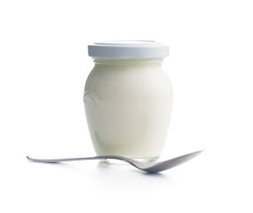 White yogurt in jar and spoon isolated on white background.