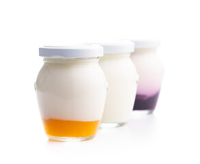 White and fruity yogurt in jar isolated on white background.