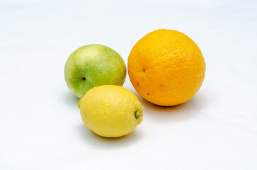 Orange green-apple and lemon on white