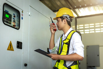 Electrical engineer working in control room. Electrical engineer man checking Power Distribution...