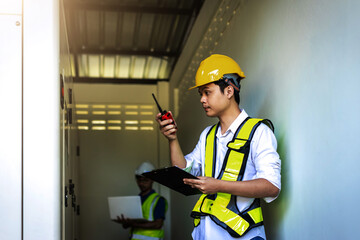 Electrical engineer working in control room. Electrical engineer man checking Power Distribution Cabinet in the control room