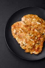Delicious fried chicken breast in batter with mustard, salt, spices and cheese
