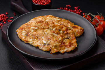 Delicious fried chicken breast in batter with mustard, salt, spices and cheese