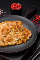 Delicious fried chicken breast in batter with mustard, salt, spices and cheese