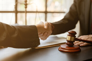 Businessman shaking hands to seal a deal with his partner lawyers or attorneys discussing a contract agreement.Legal law, advice, and justice concept