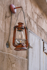 Rural view on ancient lamps and weathered walls in sunny heritage village