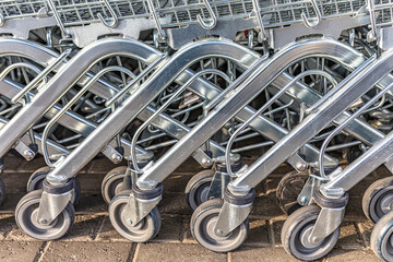 Shopping carts by a supermarket . Shopping Trolley in a Row