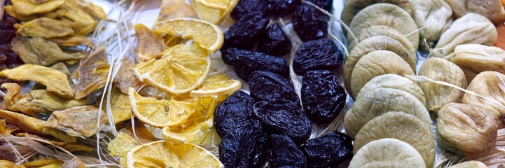 Dried fruit background. Rows of dried dates, apricots, lemon, prunes and figs.