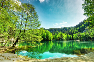 Blue lake, pine forest in Adrspach-Teplice Rock Town, Czech Republic. Beauty national park with lake and green fir woodland