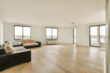 an empty living room with wood flooring and large windows looking out onto the cityscapearl view