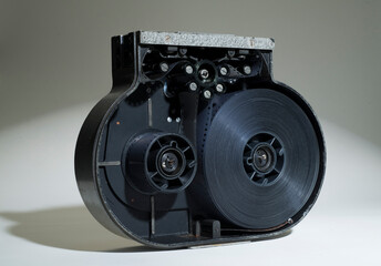 film in cassette for movie camera.open cassette with film reel.cinema technology concept