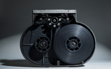 film in cassette for movie camera.open cassette with film reel.cinema technology concept