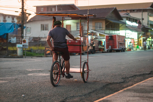 Unknown street vendor on a trycycle rolling on the main street of Bocas Del Toro island village, touristic spot in the panama part of caribbean.