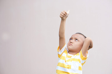 Asian boy doing his hand as a great sign