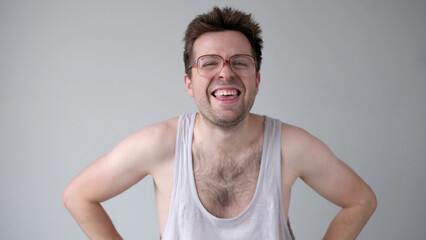 European man with big glasses is laughing foolishly.