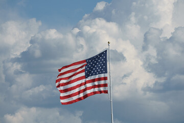 American Flag flying on flag pole in storm 