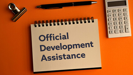 There is notebook with the word Official Development Assistance. It is as an eye-catching image.