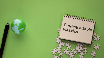 There is notebook with the word Biodegradable Plastics. It is as an eye-catching image.