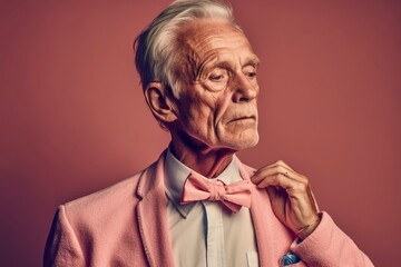 Fototapeta premium An elegant gentleman, with a bow tie, retired, in a studio photo. Ai generated.