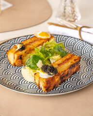 Fancy mini  caviar sandwiches on a blue plate