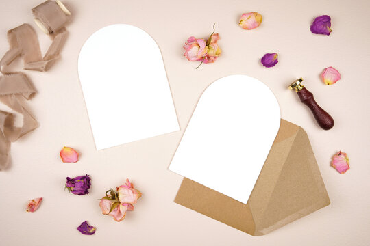 5x7 arch card wedding stationery suite mockup. Styled with silk ribbon, vintage wax seal and dried roses on a beige background. Double side vertical orientation.