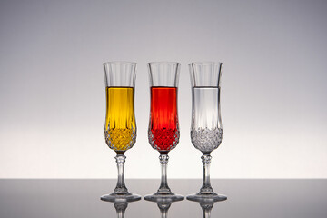 Champagne glass on shiny gray surface