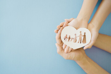 Hands holding diversity family in heart shape, happy carer and volunteer, disable nursing home, rehabilitation and health insurance concept - obrazy, fototapety, plakaty