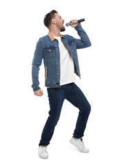 Handsome man with microphone singing on white background