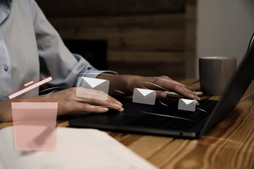 Woman working at table, closeup. Envelopes flying from laptop into trash bin, illustration of spam removing