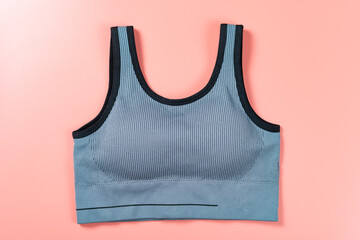grey sports bra for women on pink background - obrazy, fototapety, plakaty