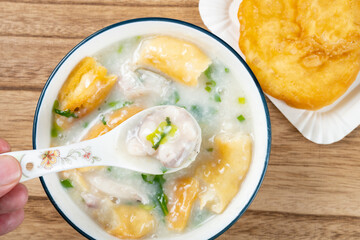 top view fish porridge with deep-fried Chinese donuts at horizontal composition