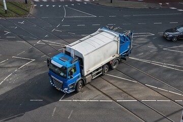 Garbage truck driving on the street