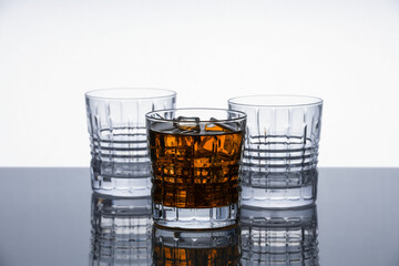 Crystal whiskey glasses on a reflective surface