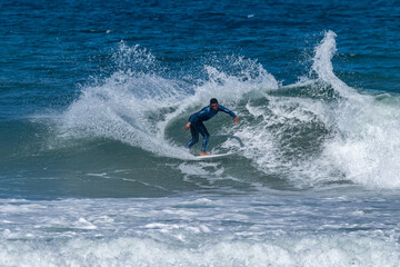 Surfer riding waves in Furadouro Beach