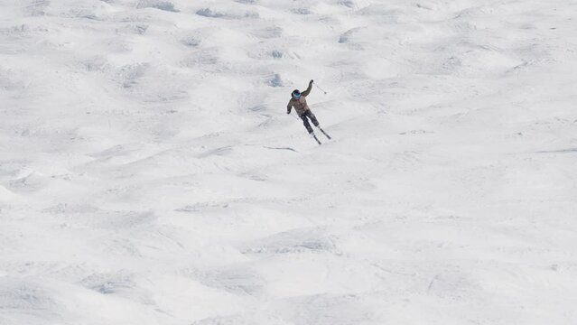 Skier Falling In Snow On Downhill Slope