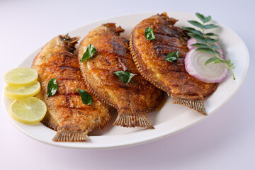 Kerala fish curry Karimeen Pollichathu a popular hot and spicy baked fish in banana leaves Alleppey India. Pearl spot fish marinated with Indian spices then wrapped in plantain banana leaf grilled.