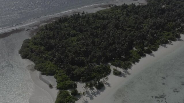A beautiful bird's eye view of tropical islands in the Maldives. Aerial photography of exotic tropical islands. Footage without color correction.