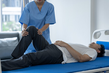A physiotherapist or medical professional is doing counseling and physiotherapy on the knee and leg...