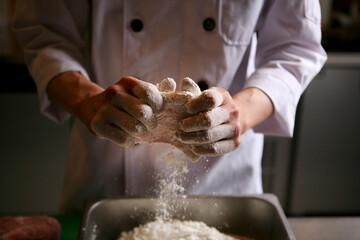 The cook is making pork cutlet.