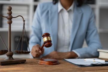 Fototapeta na wymiar justice and legal concept judge, lawyer, american businesswoman african with hammer scales of justice available on the desk in the office Legal concepts and consulting services.